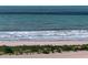 Coastal view showcasing a beautiful beach with ocean waves and lush greenery at 1270 Gulf Blvd # 501, Clearwater Beach, FL 33767