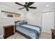 Cozy bedroom with a ceiling fan, bed with blue and white striped bedding, and a chest of drawers at 1270 Gulf Blvd # 501, Clearwater Beach, FL 33767