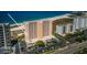Picturesque view of a high rise on a white sand beach near a beautifully landscaped parking area at 1270 Gulf Blvd # 501, Clearwater Beach, FL 33767