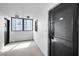 Bright hallway featuring tiled floors, windows, and unit entrance with unit number 501 at 1270 Gulf Blvd # 501, Clearwater Beach, FL 33767
