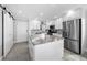 Bright and modern kitchen with white cabinets, stainless steel appliances, and marble-look island at 1270 Gulf Blvd # 501, Clearwater Beach, FL 33767