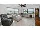 Bright living room featuring a sectional sofa, recliner, ceiling fan and stunning ocean views at 1270 Gulf Blvd # 501, Clearwater Beach, FL 33767