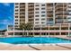 Outdoor pool view showcasing lush landscaping and surrounding residential buildings at 1270 Gulf Blvd # 501, Clearwater Beach, FL 33767