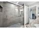 Modern shower with glass door, shower bench, and view of the bathroom with granite counters and vanities at 1270 Gulf Blvd # 501, Clearwater Beach, FL 33767