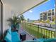 Comfortable outdoor seating on the balcony with a view of the beach and pool area at 1430 Gulf Blvd # 102, Clearwater Beach, FL 33767