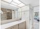 Well-lit bathroom boasting neutral tile, a modern vanity, and a glass-enclosed shower, creating a peaceful atmosphere at 1430 Gulf Blvd # 102, Clearwater Beach, FL 33767