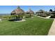Lush grassy area with tiki hut-style umbrellas and seating at this beachfront condo community at 1430 Gulf Blvd # 102, Clearwater Beach, FL 33767