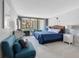 Serene bedroom with a blue-themed decor, balcony access, and comfortable seating area at 1430 Gulf Blvd # 102, Clearwater Beach, FL 33767