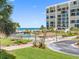 Community pool, beach, and manicured grounds at 1430 Gulf Blvd # 102, Clearwater Beach, FL 33767