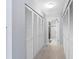 Hallway leading to bathroom showing a door and multiple closet doors for storage at 1430 Gulf Blvd # 102, Clearwater Beach, FL 33767