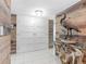 Entryway featuring wood-paneled walls, white doors, tile flooring, and decorative heron sculpture at 1430 Gulf Blvd # 102, Clearwater Beach, FL 33767