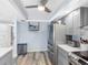 Updated kitchen featuring gray cabinets, stainless steel appliances, and wood-look flooring at 1430 Gulf Blvd # 102, Clearwater Beach, FL 33767