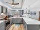 Renovated eat-in kitchen featuring updated appliances, gray cabinets, and a long quartz countertop at 1430 Gulf Blvd # 102, Clearwater Beach, FL 33767