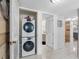 Functional laundry area with stacked washer and dryer, conveniently located near the bathroom at 1430 Gulf Blvd # 102, Clearwater Beach, FL 33767