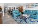 Bright living room showcasing comfortable blue sofas, a decorative rug, and a view of the modern kitchen at 1430 Gulf Blvd # 102, Clearwater Beach, FL 33767
