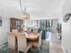 Open-concept living and dining area with sliding glass doors to the balcony at 1430 Gulf Blvd # 102, Clearwater Beach, FL 33767