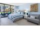 Comfortable bedroom with balcony access, serene blue walls, and stylish decor, creating a relaxing retreat at 1430 Gulf Blvd # 102, Clearwater Beach, FL 33767