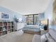 Sunlit bedroom with a cozy daybed, beachfront views, a stylish bed, and ample storage space at 1430 Gulf Blvd # 102, Clearwater Beach, FL 33767