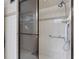 Neutral tiled shower with grab bar, handheld shower head and glass doors at 1430 Gulf Blvd # 102, Clearwater Beach, FL 33767