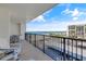 Relaxing balcony view of the beach with outdoor seating and a black metal railing at 1460 Gulf Blvd # 406, Clearwater Beach, FL 33767