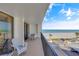 Charming balcony with seating area overlooking the beach and blue ocean at 1460 Gulf Blvd # 406, Clearwater Beach, FL 33767