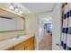 Bathroom featuring a single vanity with bedroom view, perfect for relaxation at 1460 Gulf Blvd # 406, Clearwater Beach, FL 33767