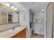 Bathroom with a large mirror, single sink vanity, and a walk-in shower at 1460 Gulf Blvd # 406, Clearwater Beach, FL 33767