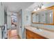 Bathroom with a single sink vanity, a mirror, and a view into the bedroom at 1460 Gulf Blvd # 406, Clearwater Beach, FL 33767