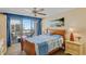 Cozy bedroom with access to balcony, water view and ceiling fan at 1460 Gulf Blvd # 406, Clearwater Beach, FL 33767