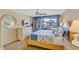 Well lit, cozy bedroom with balcony, a dresser, and view to beach at 1460 Gulf Blvd # 406, Clearwater Beach, FL 33767