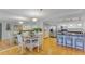 Cozy dining area with a round table set for a meal, adjacent to a modern kitchen at 1460 Gulf Blvd # 406, Clearwater Beach, FL 33767