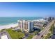 Luxury condos overlooking a pristine beach, featuring a pool and well-maintained landscaping at 1460 Gulf Blvd # 406, Clearwater Beach, FL 33767