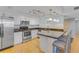Modern kitchen featuring stainless steel appliances, granite countertops, and a breakfast bar with seating at 1460 Gulf Blvd # 406, Clearwater Beach, FL 33767