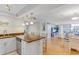 Open kitchen with stainless steel appliances, island seating, and views into the dining and living areas at 1460 Gulf Blvd # 406, Clearwater Beach, FL 33767
