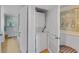 Efficient laundry closet with stacked washer and dryer and art at 1460 Gulf Blvd # 406, Clearwater Beach, FL 33767