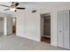 Bedroom with neutral walls, tiled floors with adjacent bathroom and closet providing space and convenience at 1655 S Highland Ave # D140, Clearwater, FL 33756