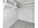 Walk-in closet with built-in white shelves provide ample storage space and organization at 1655 S Highland Ave # D140, Clearwater, FL 33756