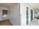 Condo building exterior featuring the front door and sliding glass doors along a walkway at 1655 S Highland Ave # D140, Clearwater, FL 33756