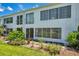 Charming two-story exterior with lush landscaping and a cozy patio, perfect for outdoor entertaining at 1655 S Highland Ave # D140, Clearwater, FL 33756