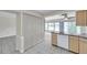Kitchen view from living room featuring tile floors, pantry, and nearby appliances at 1655 S Highland Ave # D140, Clearwater, FL 33756