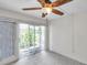 Light filled living room features tile floors, and a large sliding glass door for a seamless indoor/outdoor flow at 1655 S Highland Ave # D140, Clearwater, FL 33756