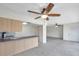 Open-concept living room and kitchen area with tile flooring and ceiling fans at 1655 S Highland Ave # D140, Clearwater, FL 33756