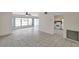 Living room and kitchen with neutral tile floor, ceiling fan, and open floor plan at 1655 S Highland Ave # D140, Clearwater, FL 33756