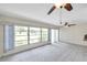 Living room with large window, tile floors, and ceiling fan at 1655 S Highland Ave # D140, Clearwater, FL 33756