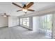 Bright living room with sliding glass doors and a ceiling fan offering seamless indoor-outdoor living at 1655 S Highland Ave # D140, Clearwater, FL 33756