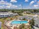 Overhead shot of a community pool with surrounding lounge area and shuffleboard, nestled in a well-maintained residential setting at 1655 S Highland Ave # D140, Clearwater, FL 33756