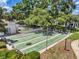Close up of shuffleboard courts in a residential community, surrounded by lush greenery and mature trees at 1655 S Highland Ave # D140, Clearwater, FL 33756