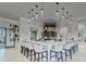 A stylish bar area offers seating and a television for entertaining at 16840 Whisper Elm St, Wimauma, FL 33598