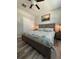 Spacious bedroom with a nautical-themed king bed, luxury vinyl flooring, and recessed lighting creating a relaxing atmosphere at 16840 Whisper Elm St, Wimauma, FL 33598