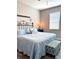 Charming bedroom with a comfortable bed, soft blue bedding, and ample natural light at 16840 Whisper Elm St, Wimauma, FL 33598